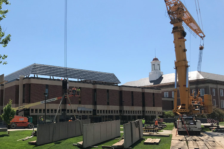 Cranes removing screenwall from UNL's Love Library