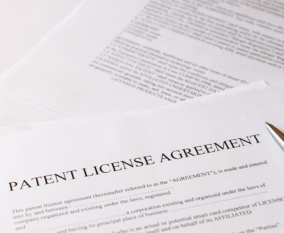 Pen and paper titled "Patent License Agreement"