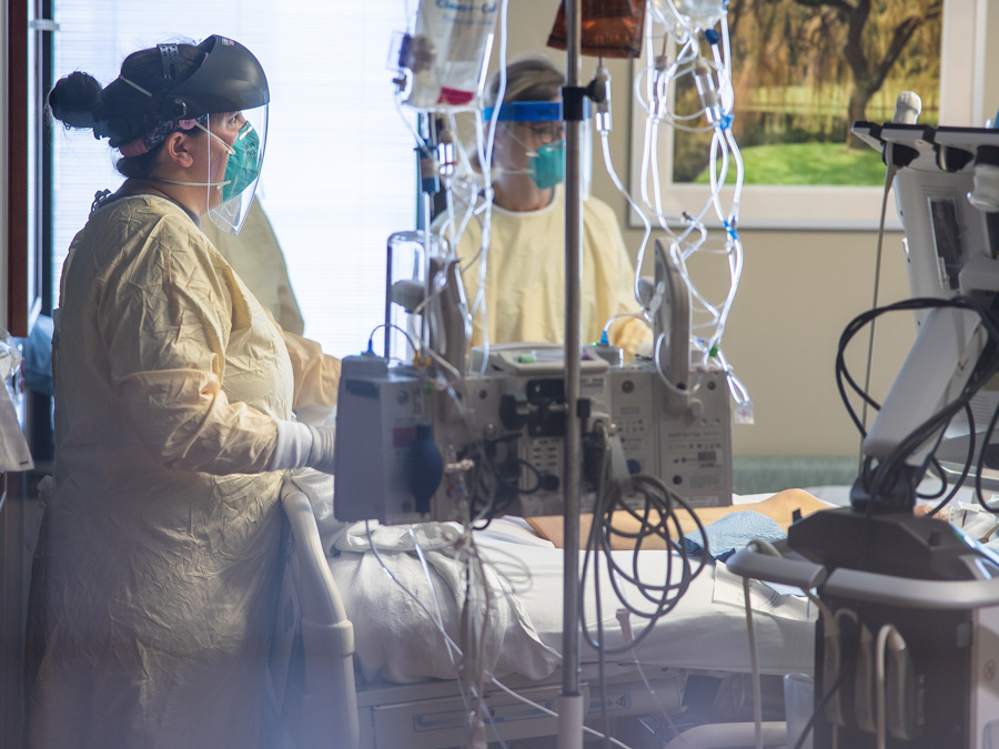 Nurses and doctors intubating a COVID-19 patient in the COVID ICU unit at Nebraska Medicine
