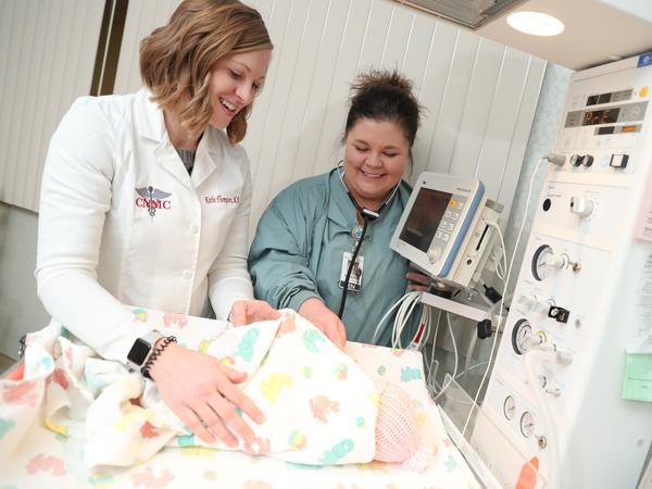 Katie Thompson and another medical professional attending to baby in NICU