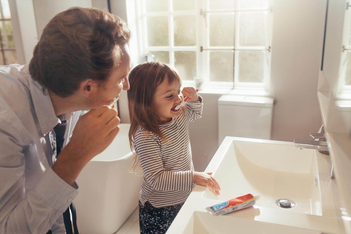 Father and Daughter brushing teeth