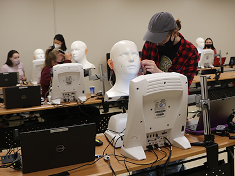 UNL audiology student working with hearing improvement technology.