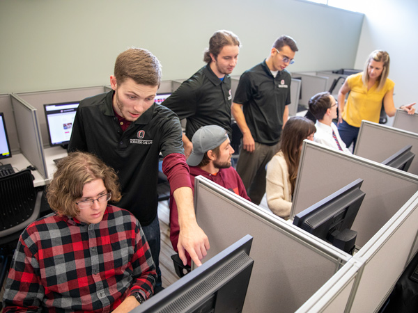 students gathered around a digital medical learning device