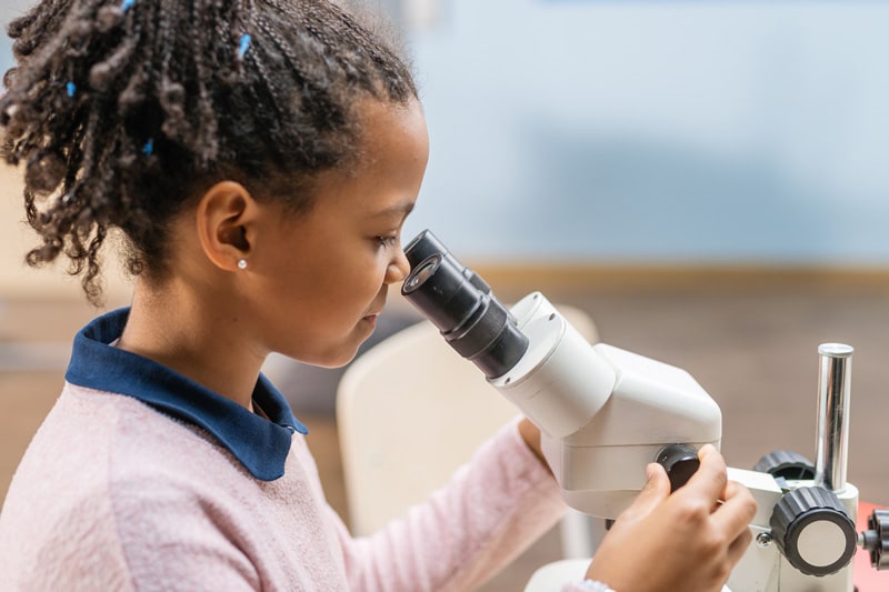 STUDENT WITH MICROSCOPE