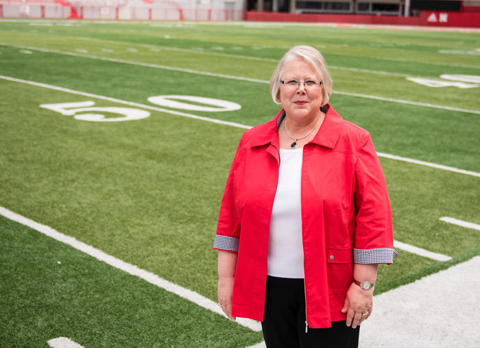 Dr. Susan Fritz on the 50-yard line at Memorial Stadium. She believes we should win on the field, in the classroom and lab, and in the community.