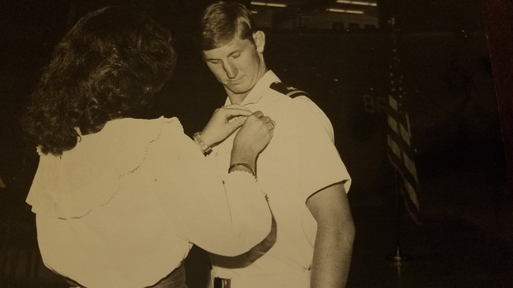 Lynda pins Ted's uniform in a black and white throwback photo