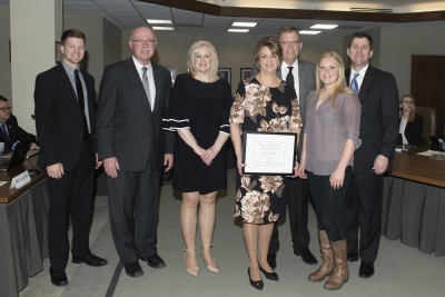 Regent Krejdl; Charles Bicak, Sr. Vice Chancellor of Academic and Student Affairs; Tami Plugge, Supervisor and Executive Associate in Academic Affairs; Kristi Milks, recipient; Alan Milks, husband; Macy Zwiener, daughter; President Bounds