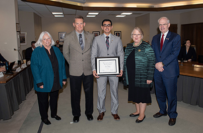 Erik Palafox, a software engineer in development and operations in the UNMC Department of Information Technology., receiving his KUDO's award.