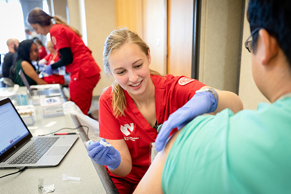 Individual drawing fluids from a donor for the Big Ten blood drive