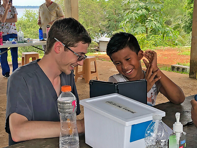 Bailey Premer laughing with child in Panama
