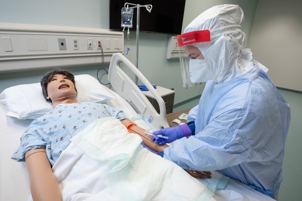 student with mannequin in Global Center for Health Security 