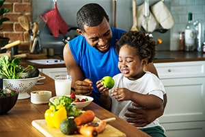 Father feeding his son healthy foods