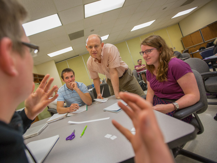 students gathered around a digital medical learning device