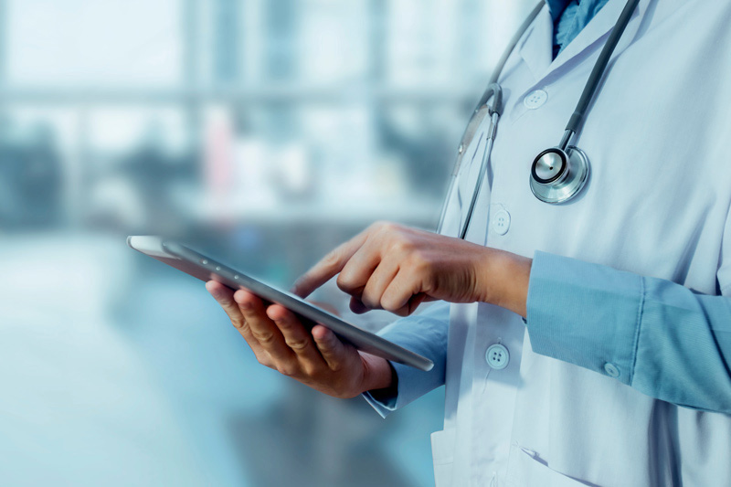 healthcare worker entering information on tablet