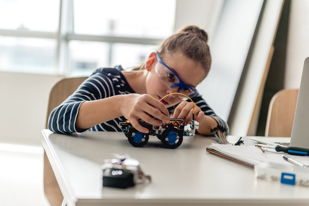 Student working with a small robot car